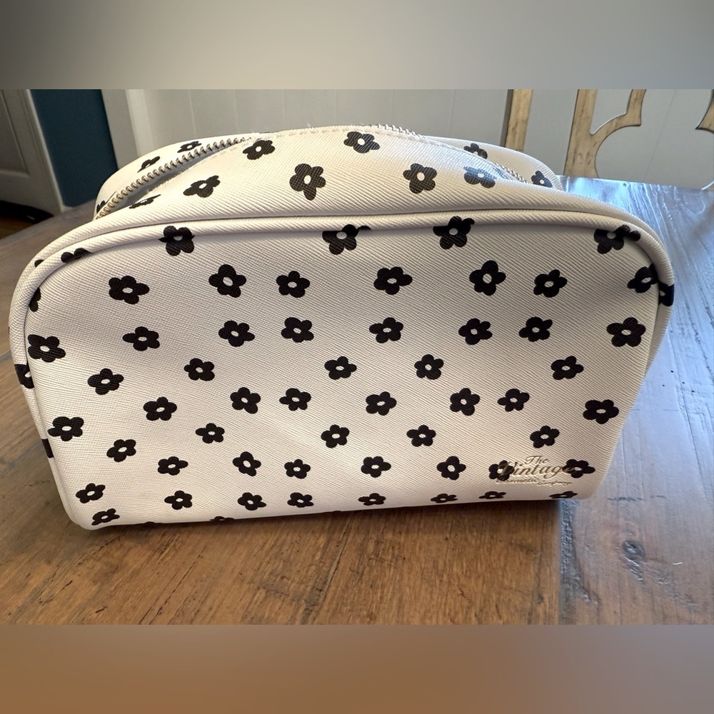 The Vintage Cosmetic Company makeup bag. White with black flower print.